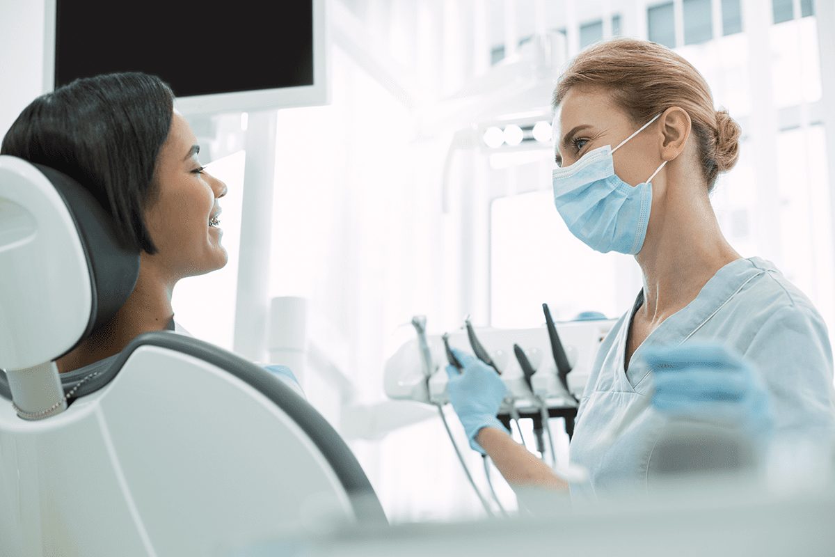 dentist looking at patient before dental check-up