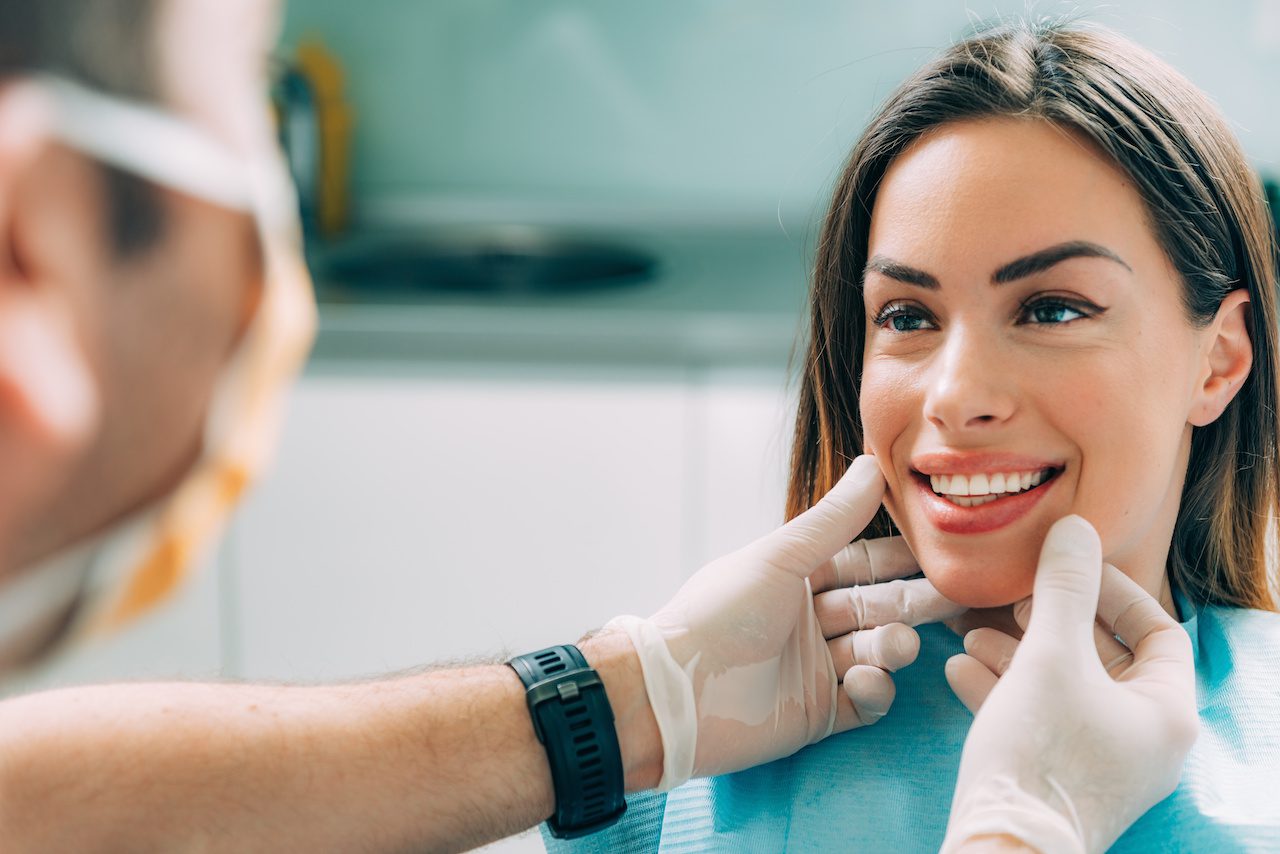 dentist giving women cosmetic dentistry recommendations at clinic