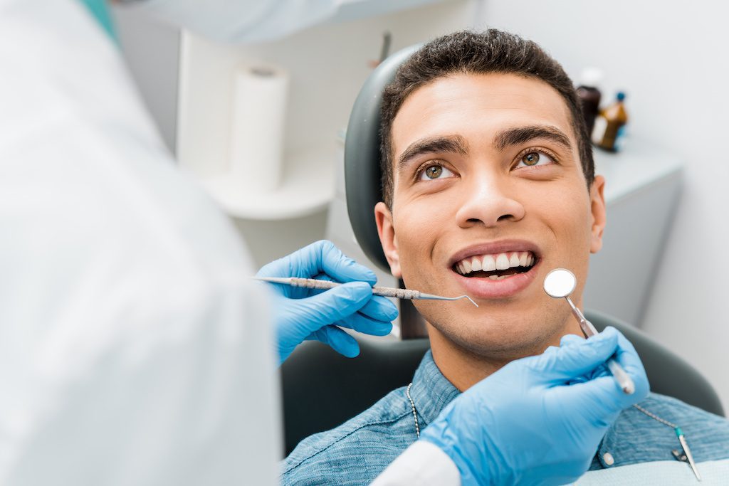 man getting dental check-up at lewis dental