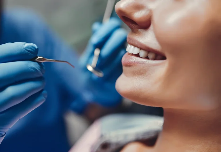 patient sits in dentist chair for check up
